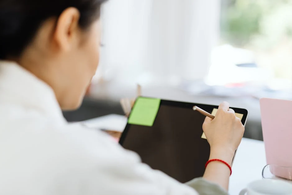 A person uses a stylus on a tablet with sticky notes, perhaps planning conversion rate optimization healthcare strategies for a medical website.